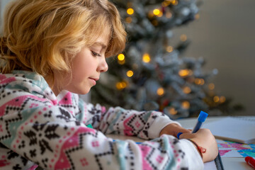 Child writing letter to Santa Christmas New Year holiday, cosy home Christmas decoration and lights, girl dreaming drawing colorful pencils preparing gifts presents for family, boy wishing Santa Claus