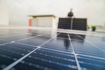 A worker installs or maintains solar panels on a rooftop. The image highlights renewable energy technology, solar power systems, and the role of workers in implementing sustainable energy solutions.