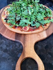 arugula and fig on top of pizza pie