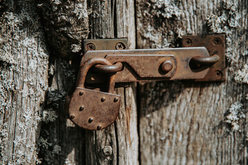 Boarded up old wooden door with padlock