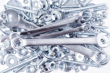 Composition with a variety of metal tools.Sockets, tools,spanners and bits.Wrenches on nuts and bolts. Industrial background.Close-up of various screws. Use for background,