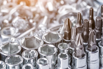 Composition with a variety of metal tools.Sockets, tools,spanners and bits.Mixed screws and nails....