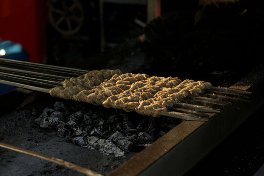 sekh kabab are cooking over coals, Assorted Food Grilling on Barbecue, Shish Kebab on Grill, seekh kabab grill bar b q, Outdoor Bar B Q Party, Shish kebab on the grill with coals.
