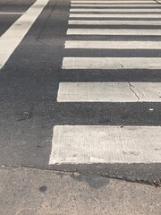 white lines of a pedestrian path to cross the street