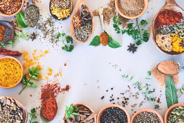 Spices, organic and selection of herbs seasoning on studio background for cooking and top view. Utensils, fresh condiments or flavor ingredients with curry leaves, masala powder and ground pepper