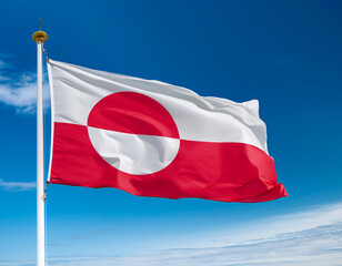 Greenland flag waving in the wind against a blue sky background
