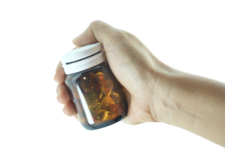 Female hand holding brown antibiotic bottle isolated on transparent background.