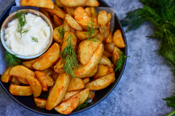  Home made Wedges spicy Potatoes and fresh  lemon on wooden background