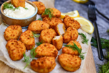 Crispy  deep fried   chicken  popcorn  nuggets and french fries . Breaded  with Cornflakes chicken  Breast fillets  with chilly peppers and fresh   basil on wooden rustic background