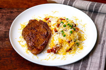 Authentic Brazilian food, grilled picanha steak with birobiro rice