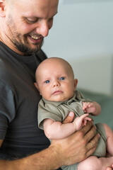 Close up portrait of happy father with newborn son.