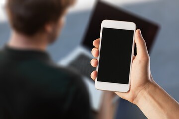 Business person using smart phone working in office