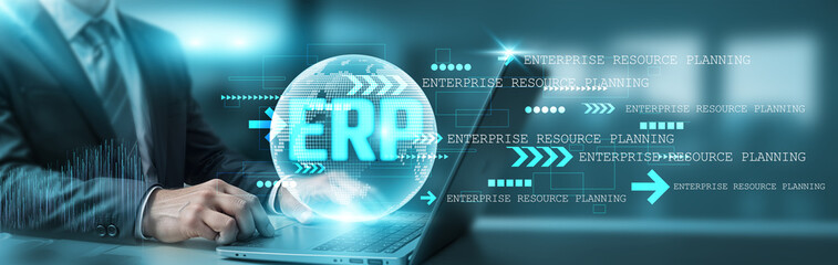 Hand holding a laptop with a global network connection, symbolizing technology and futuristic enterprise resource planning (ERP) systems, seamlessly integrating business processes across industries