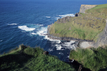 View of the cliffs of Moher, the bay and surrounding grassy rocks - Liscannor - Co. Clare - Republic of Ireland