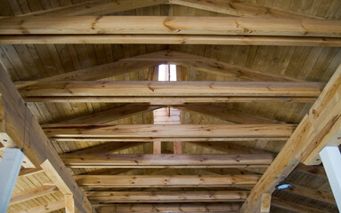 Farm stable or barn interior with wooden roof.