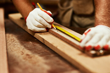Carpenter, hands and wood measuring tape for handyman work, maintenance and contractor project....
