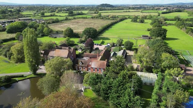 luxury property castle estate hotel basking sunshine england elegance real mansion highlighted against beautiful forward aerial shot drone uk scenic view investment unique 