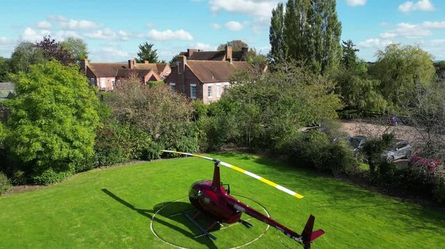 helicopter parked grass luxurious castle property england motion adds touch to scene slow front forward aerial shot luxury country house scenic view aviation 