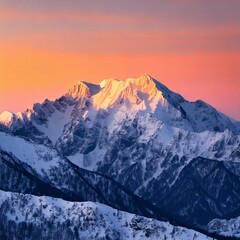 Obraz premium A white snowy mountains light pink/orange skyline background in the morning