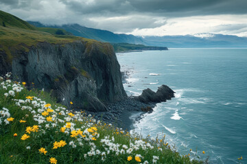 Scenic coastal landscape with wildflowers and dramatic cliffs under moody sky