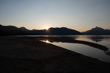 last of sun going down behind the mountain horizon at 