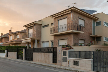 Street with detached houses at dusk, Puerto de Sagunto, Spain.