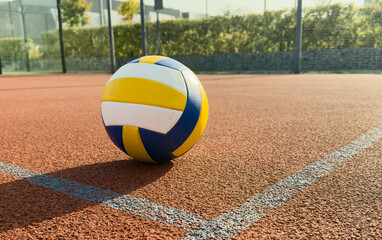 volleyball. blue with yellow color ball on the playground. volleyball cover, red. ball game