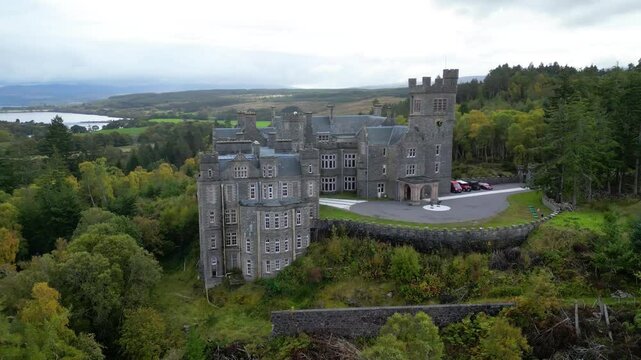 carbisdale castle architecture surrounding forest nestled highlands scotland side drone view circling aerial kyle sutherland scenic nature landscape exploration journey outdoor 