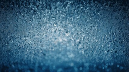 Fototapeta premium blurred winter landscape where snow gently falls, creating a frosty texture on the glass surface. The ethereal quality transforms the view into a soft, serene winter wonderland.