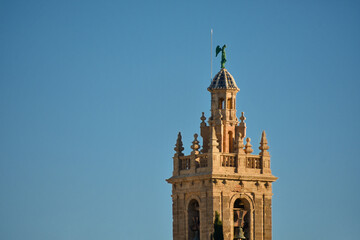 Detail of a medieval church tower isolated on a blue background