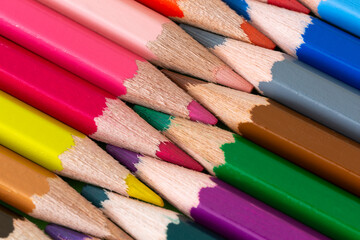 Fototapeta premium Coloring pencil tips geometric arrangement macro. Diagonal geometric coloring pencils close-up.