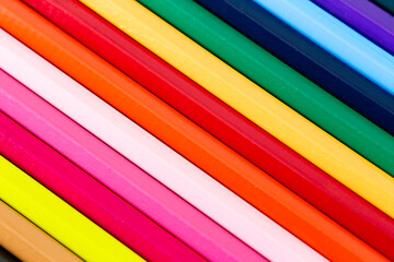 Crossed geometric coloring pencils color sticks close-up.