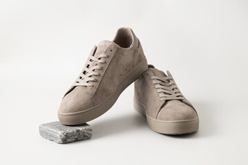 Leather nubuck gray men's gumshoes on light gray background. Close up. Men's sports casual shoes....