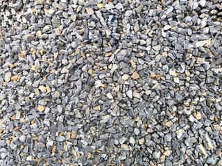 Road stone background, dark gravel pebbles stone texture seamless texture