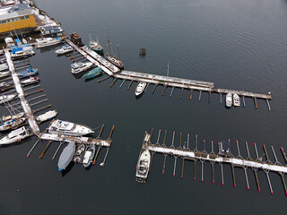Aerial winter top down of snow covered pier boats in river in Central Stockholm