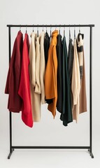 Clothes hanging on black garment rack.