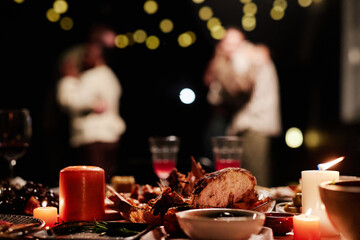 Background image of dinner table outdoors with silhouettes of couples dancing in dark, copy space