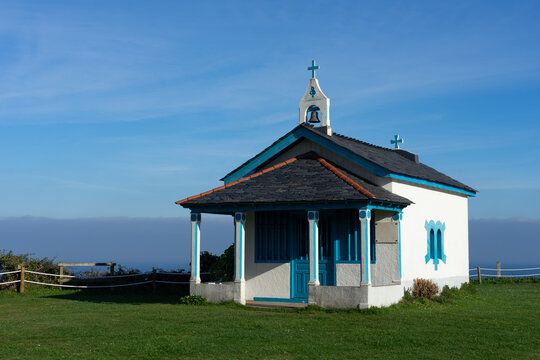 Hermitage of the Regalina with the typical Asturian horreos in Cadavedo, Asturias, Spain