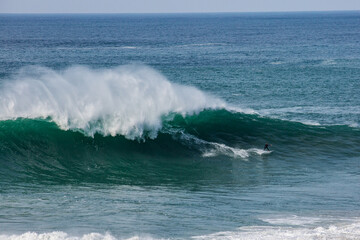 Big waves at Nazarè beach in Portugal, photographs of surfers having fun in the Atlantic Ocean