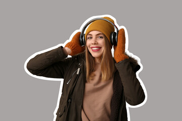 Beautiful young woman in warm winter clothes with headphones on grey background