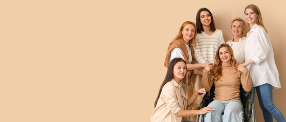 Group of people with woman in wheelchair on beige background