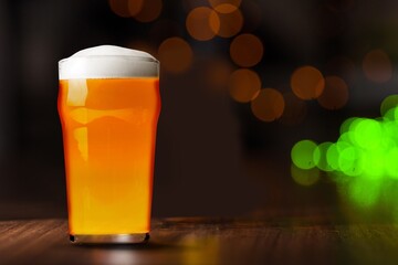 Glass of light fresh cold beer on the desk