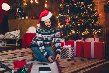 Full body portrait of nice young woman cut paper wrap book present new year xmas garland lights...