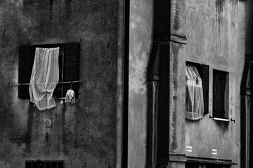 Venetian window with Halloween skull and the ancient chimney on the wall