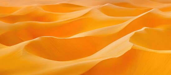 Obraz premium Abstract background of a soft, orange, flowing, wavy, and smooth fabric with a subtle texture.