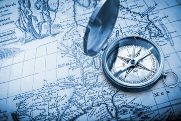Retro magnetic travel compass on map