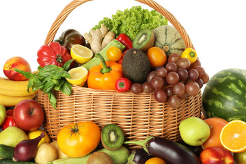Many different fruits and vegetables in wicker basket isolated on white