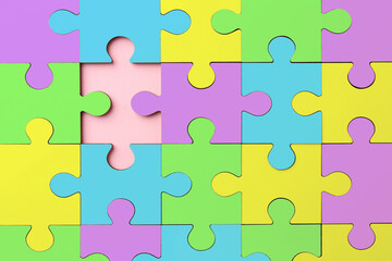 Many colorful puzzle pieces on pink background, top view. Symbol of autism