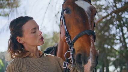 Obraz premium Tender lady petting equine in green park closeup. Happy animal enjoying touch