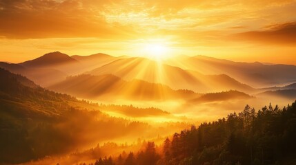 Obraz premium Breathtaking sunrise over misty mountains with vibrant colors, illuminating the landscape and creating a serene, peaceful atmosphere.